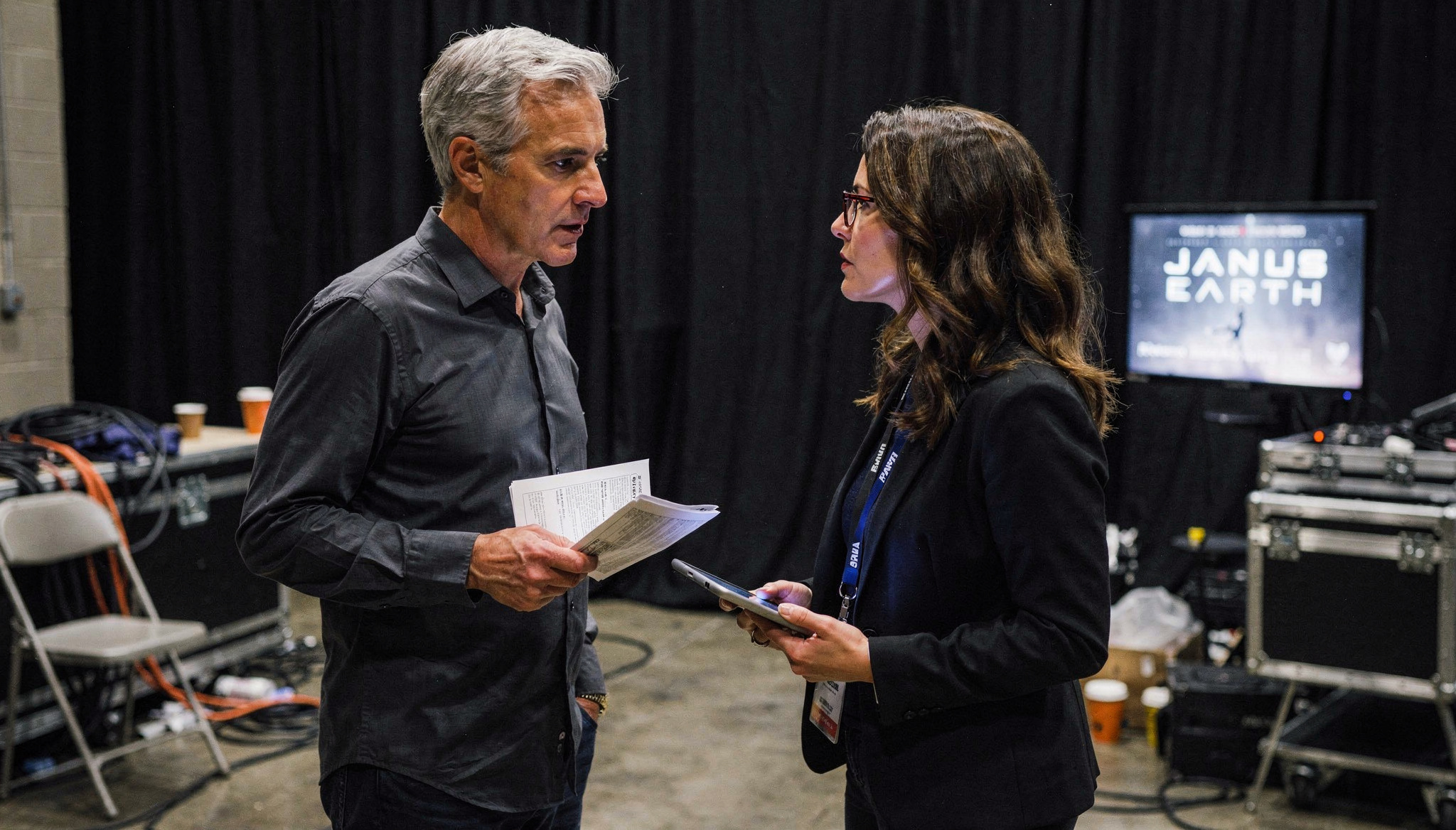 Julian Mercer and Tatiana Ardenne reviewing papers backstage before a Janus Earth session