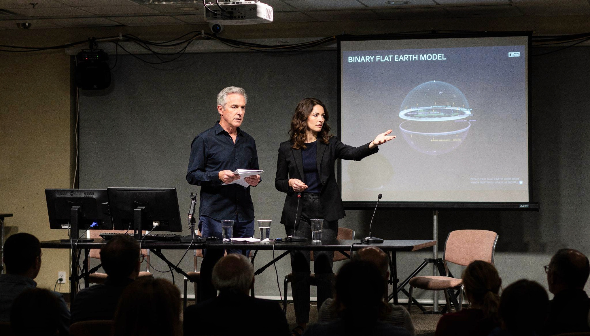 Julian Mercer and Tatiana Ardenne presenting the Janus Earth model on a public stage